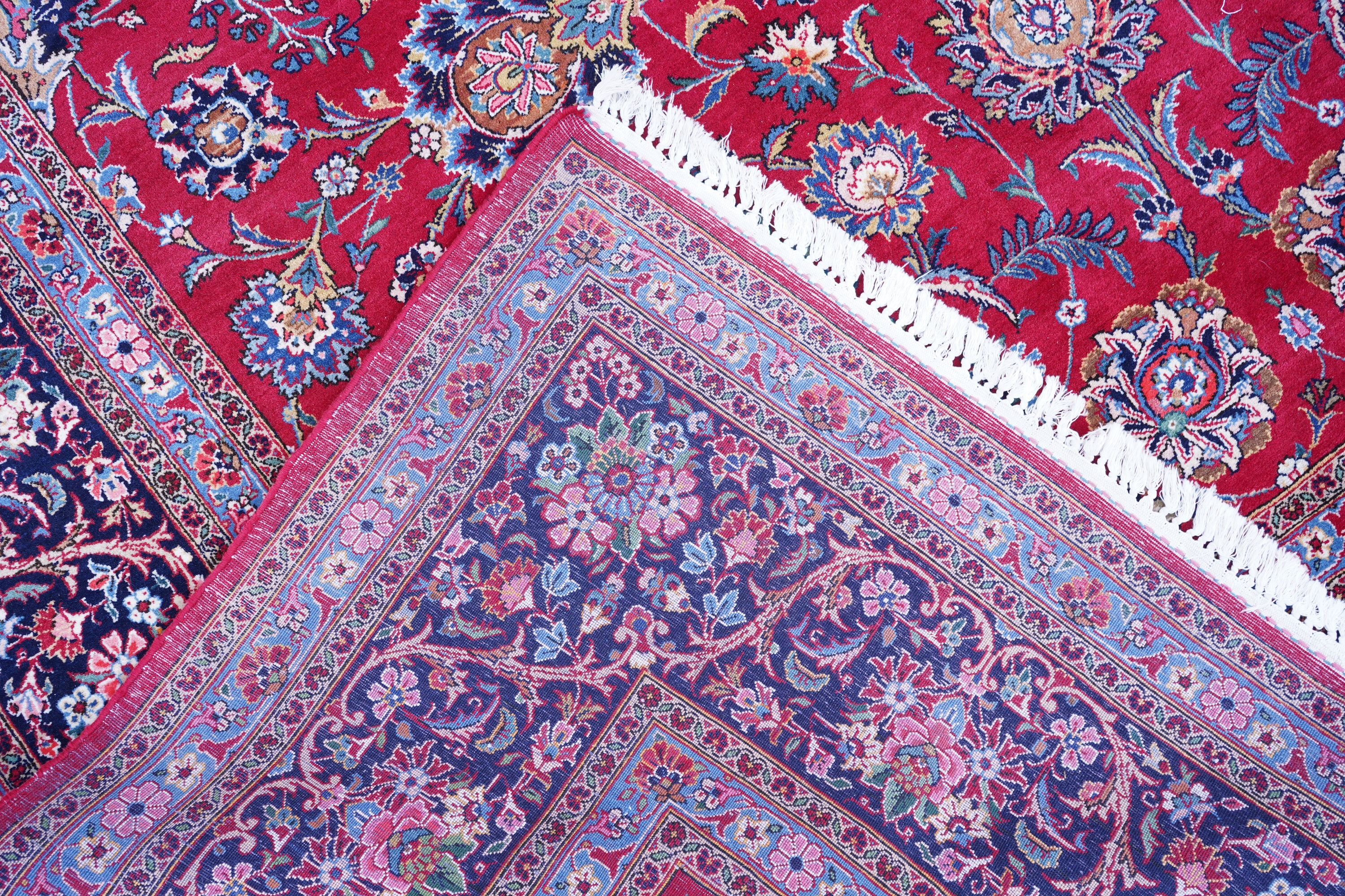 A Kashan burgundy ground carpet